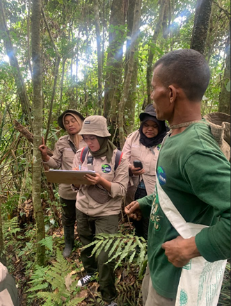 Women rangers identifying tree species during their patrol